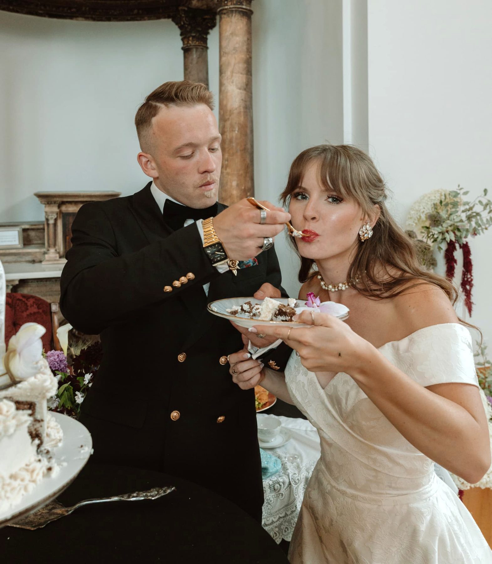 A newlywed couple sharing their wedding cake
