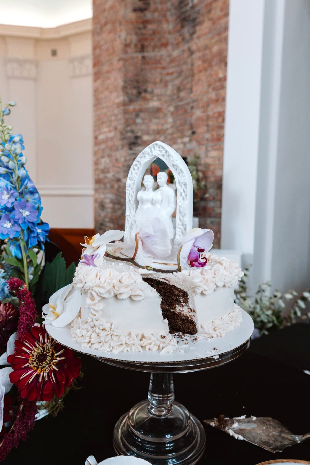 A cut slice revealing the chocolate layers of the wedding cake