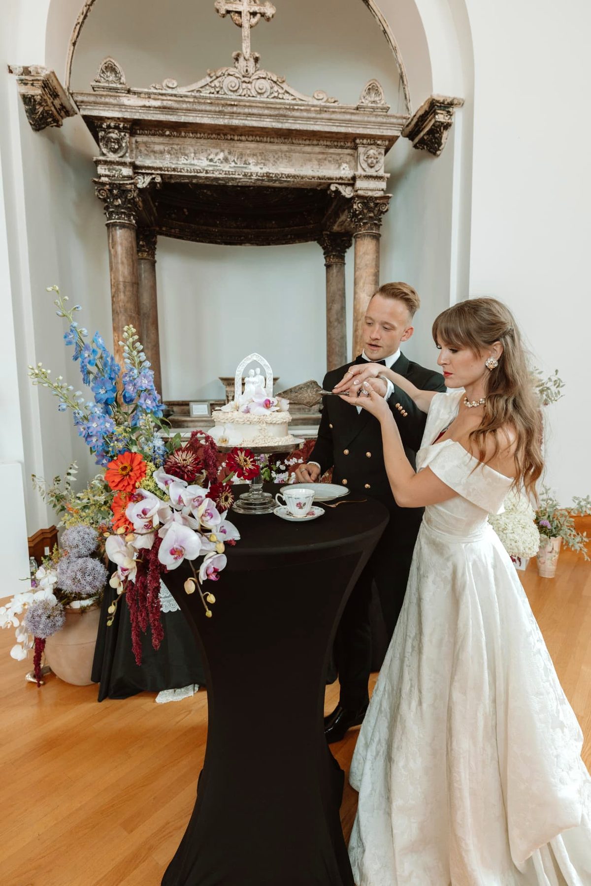 Newlyweds cutting their vintage orchid wedding cake